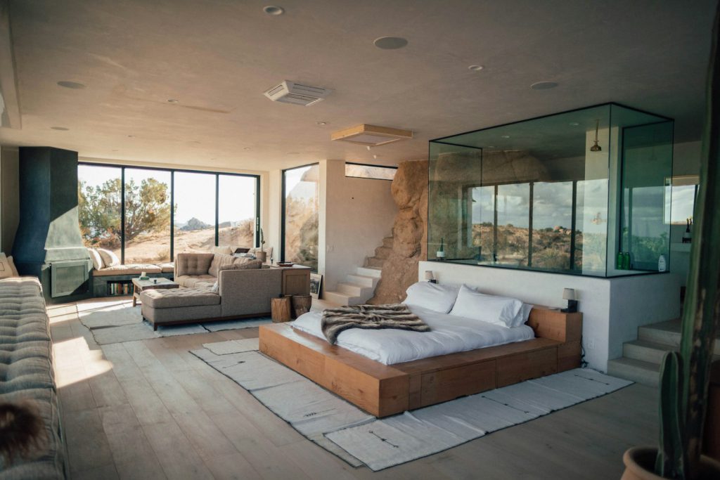 Eco-luxury room open to the sea through full-height glass