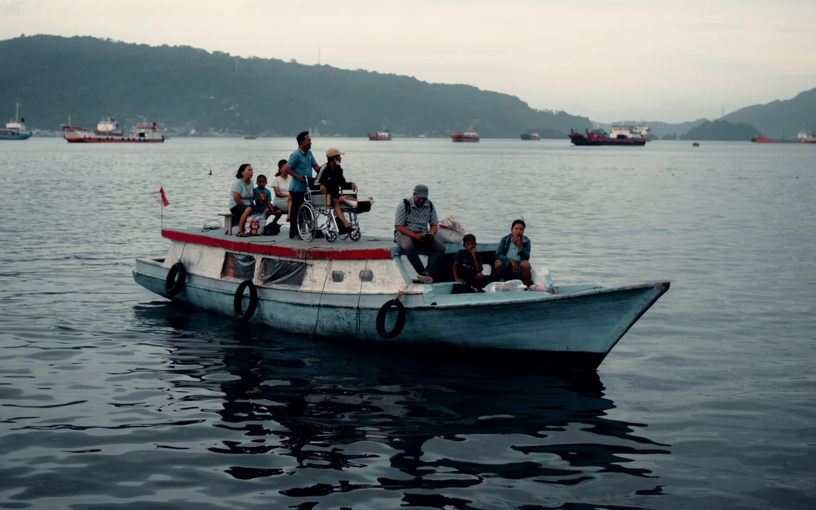 Local wooden boat carrying passengers across calm water