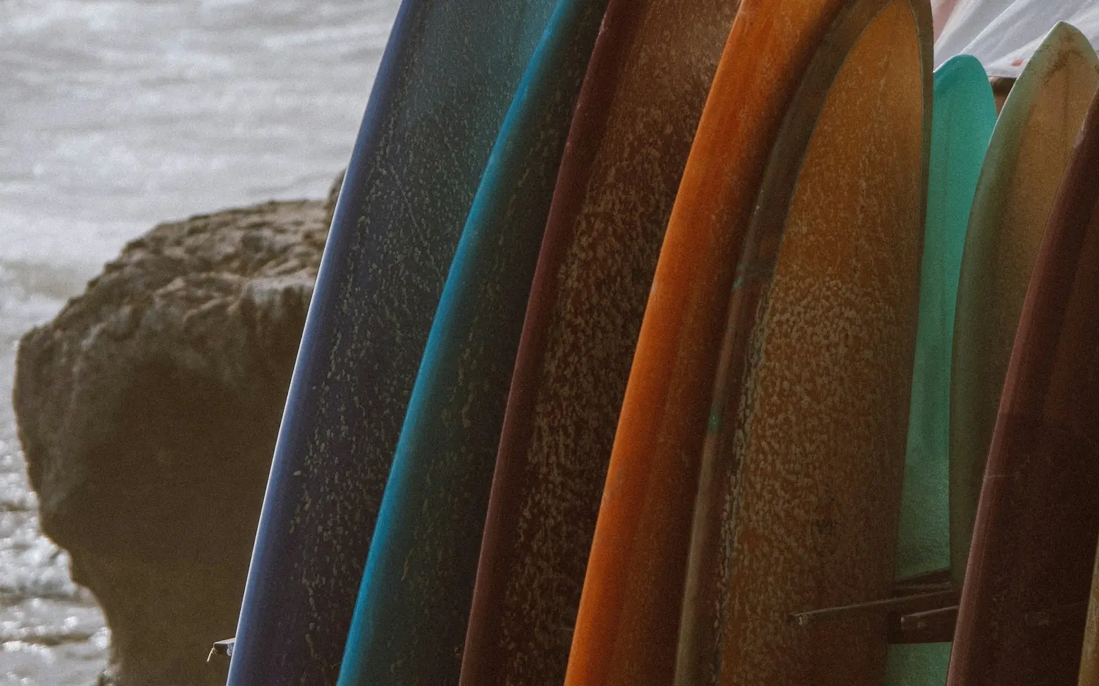 Row of board rails stacked on the sand