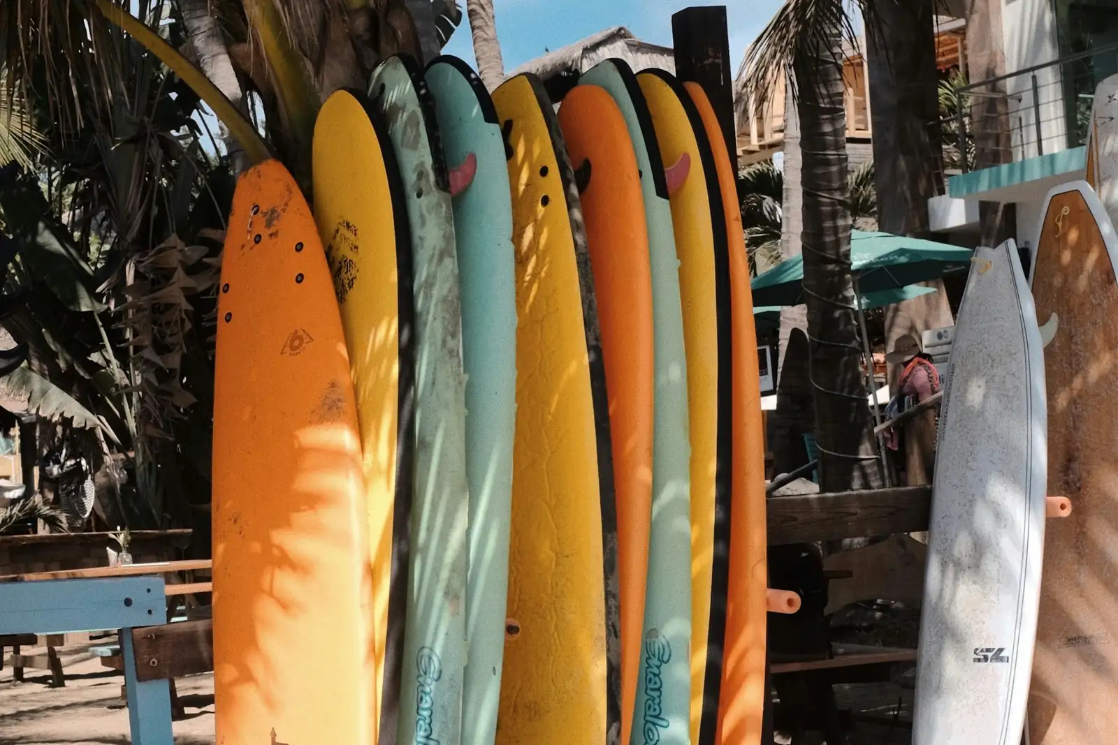 Rack of longboards standing in the shade