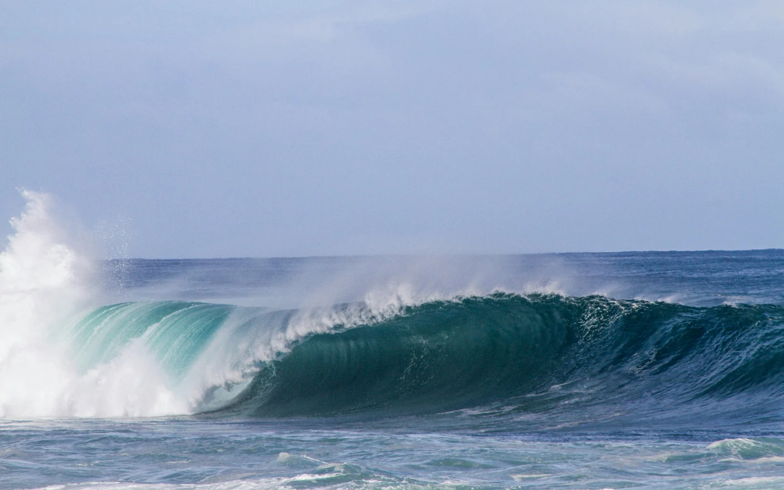 Clean reef swell under an overcast sky