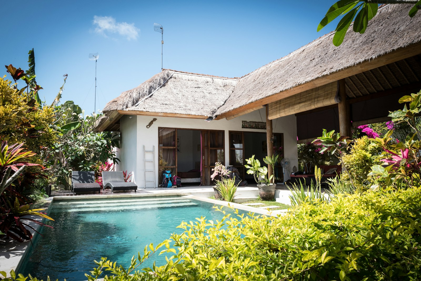 a house with a pool in front of it