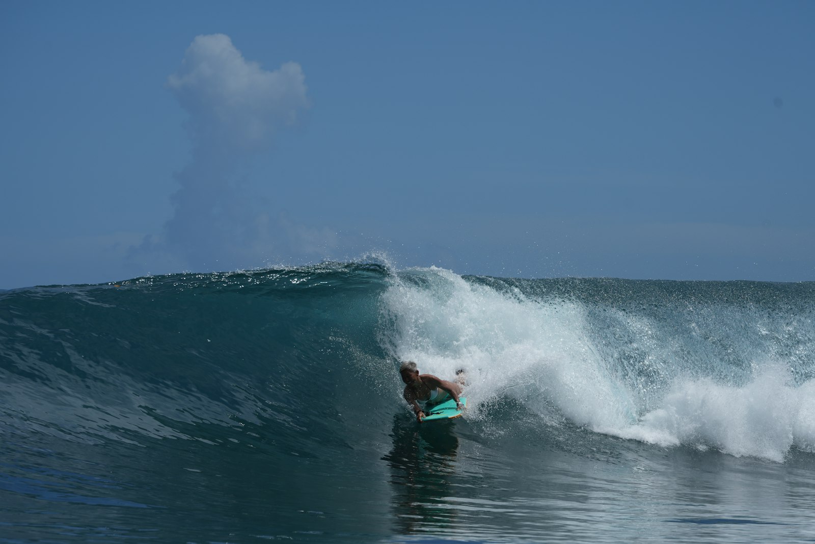 Surfer rides a large wave inside a barrel